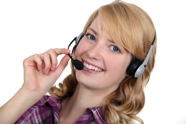 A blond woman with a headset on. — Stock Photo, Image