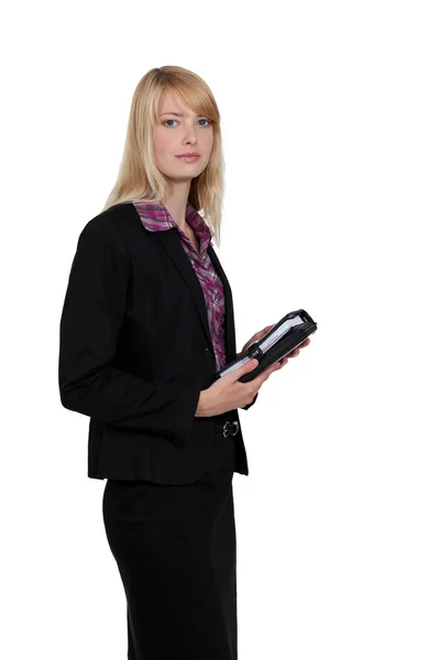 Blond businesswoman holding diary — Stock Photo, Image