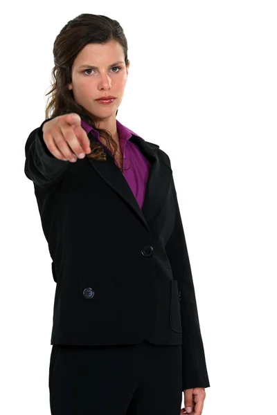 Young businesswoman pointing at someone in front of her — Stock Photo, Image