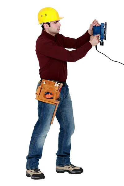 Man with an electric sander — Stock Photo, Image