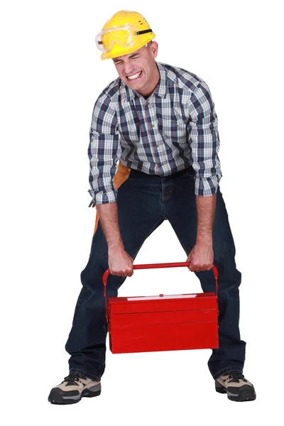 Artesano levantar caja de herramientas pesadas — Foto de Stock
