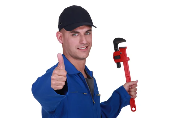 Thumbs up from a man with a wrench — Stock Photo, Image