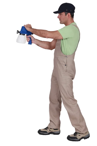 Homme utilisant un pulvérisateur de peinture — Photo