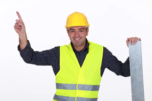 Worker in high-visibility vest pointing — Stock Photo, Image