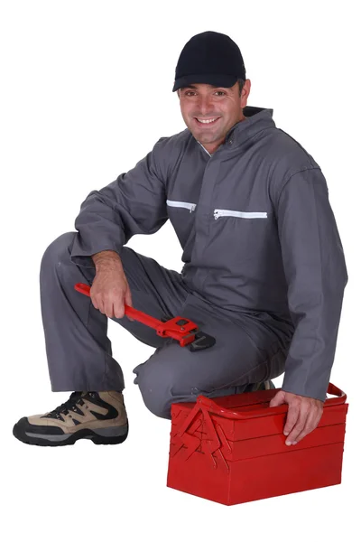 Worker sitting on a toolbox — Stock Photo, Image