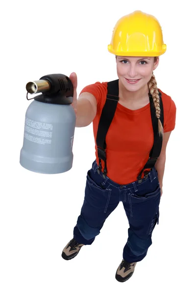 Blond woman holding blow torch — Stock Photo, Image