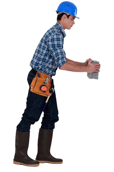 Builder carrying brick — Stock Photo, Image