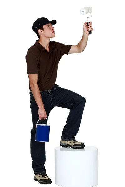 Young man holding a paint roller — Stock Photo, Image