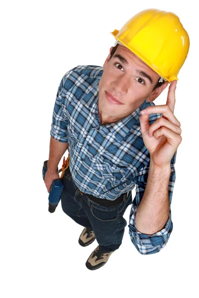 Jovem trabalhador da construção com uma broca — Fotografia de Stock