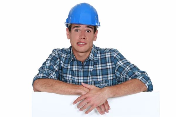 Anxious builder stood with blank board — Stock Photo, Image