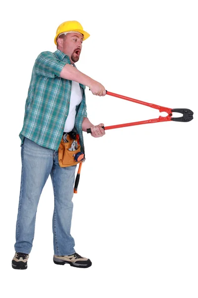 Shocked construction worker using a pair of boltcutters — Stock Photo, Image