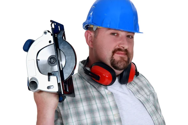 Bearded man holding circular-saw — Stock Photo, Image
