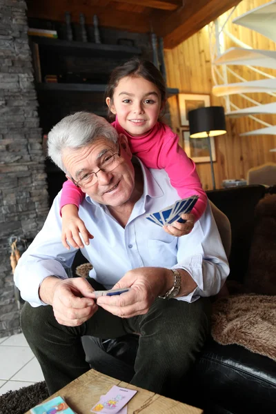 Little girl playing cards with grandpa — Stock Photo, Image