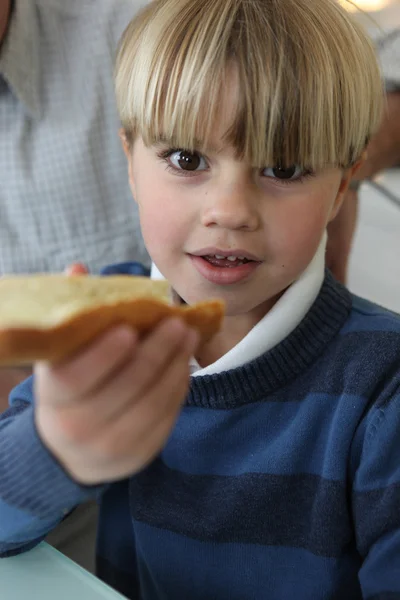 Мальчик с ломтиком хлеба — стоковое фото