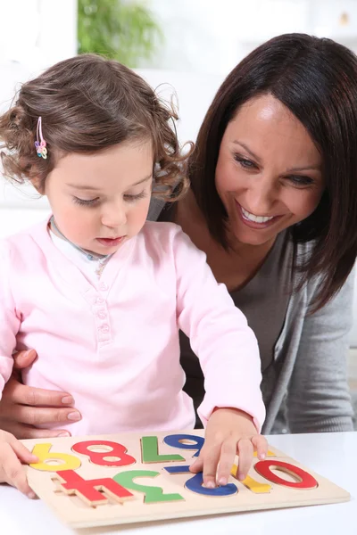 Mother and daughter playing together — Stock Photo, Image