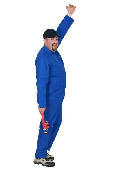 Plumber in boiler suit holding wrench Stock Photo