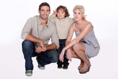 Studio shot of parents and their young son clipart