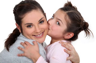 Little girl kissing her mother clipart