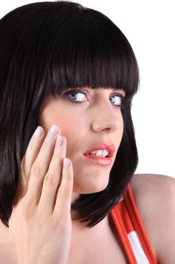 Woman touching her face clipart