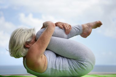 Woman holding a yoga position clipart