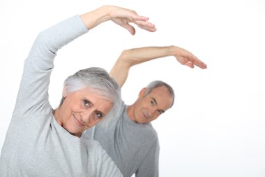 Elderly couple warming up clipart