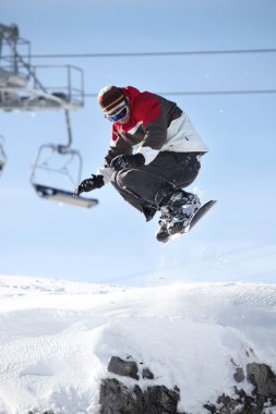 A snowboarder in mid-air clipart