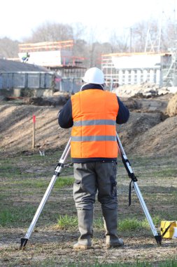 A land surveyor using an altometer clipart