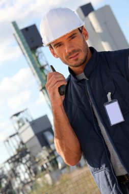 Worker on site with a walkie talkie clipart