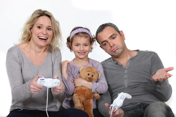 stock image Daughter watching her parents play a video game