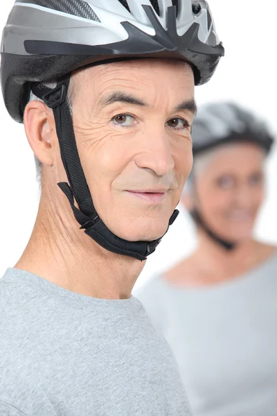 Old man and his partner wearing bike helmets — Stock Photo, Image