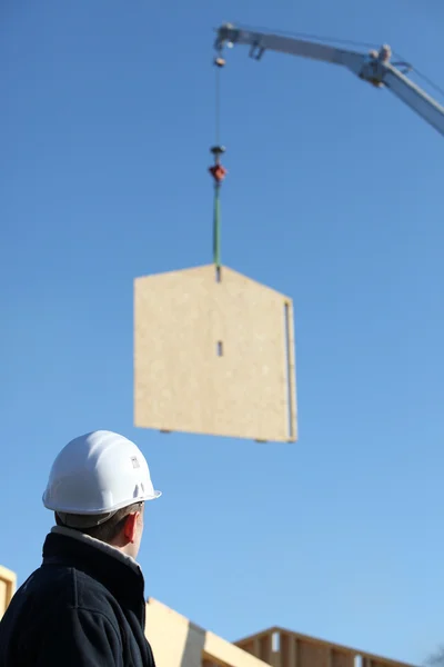 Crane lifting whole wooden wall — Stock Photo, Image