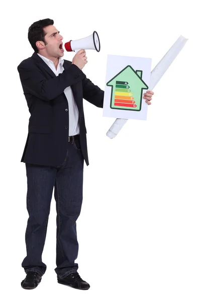 Businessman with a loudspeaker and energy rating card — Stock Photo, Image