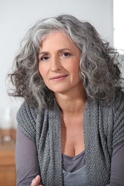 Grey-haired lady sat at home alone clipart