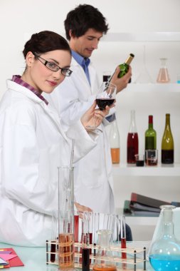 Oenologists analysing wine clipart