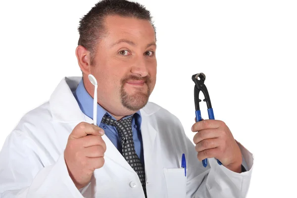 Dentist with a pair of pliers — Stock Photo, Image