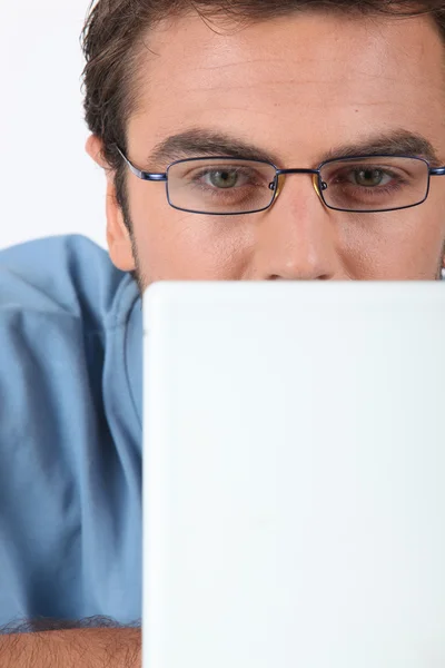 Man in glasses using laptop — Stock Photo, Image
