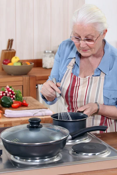 Senior woman cooking — Stock Photo, Image