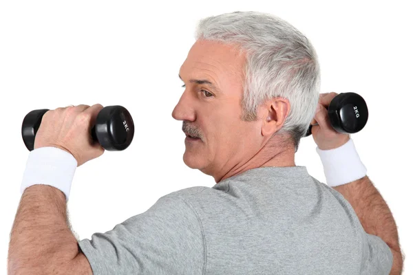 Man working out with dumbbells — Stock Photo, Image