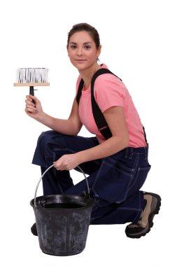 Woman kneeling by bucket of wall paper paste clipart