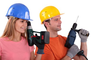 Tradespeople holding power tools clipart