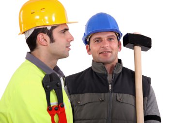 Duo of male carpenters against studio background clipart