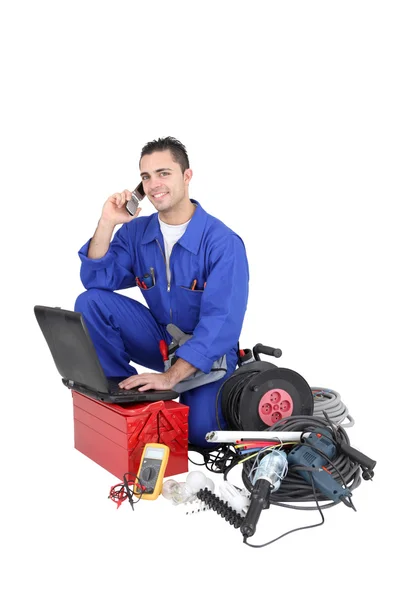 Electrician surrounded by equipment — Stock Photo, Image