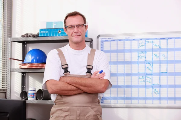 Man in de winkel met gekruiste armen — Stockfoto