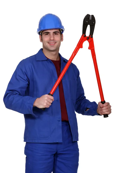 Blue collar posing with giant monkey wrench — Stock Photo, Image