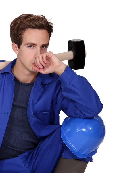 Thoughtful tradesman holding a mallet — Stock Photo, Image