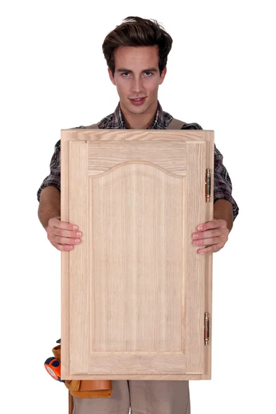 Tesař, drží dřevěné dveře — Stock fotografie