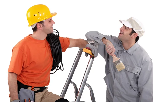 Un pintor de casa y un electricista riendo —  Fotos de Stock