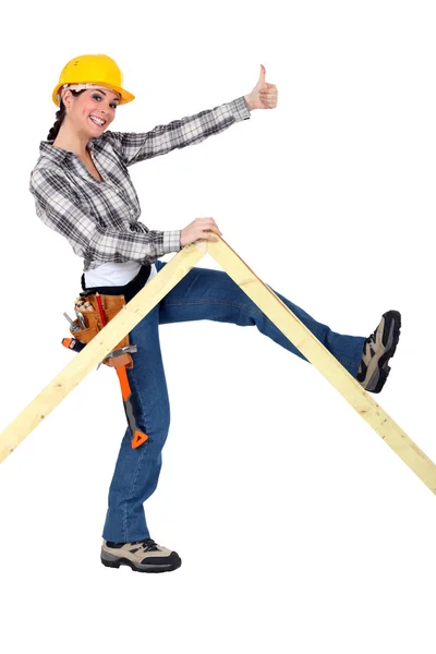 Peppy woman holding up a wooden frame — Stock Photo, Image