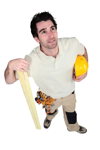 Carpenter holding plank of wood — Stock Photo, Image
