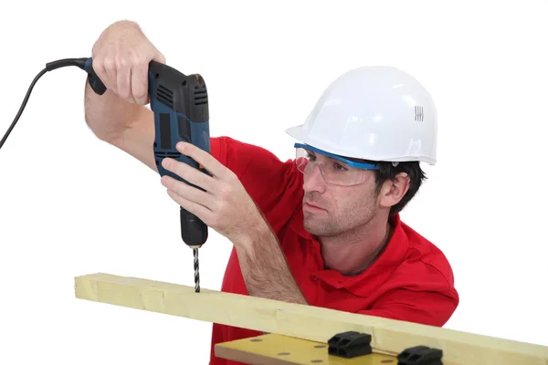 Tradesman using a power tool — Stock Photo, Image